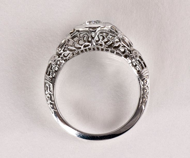 an antique style diamond ring on a white background