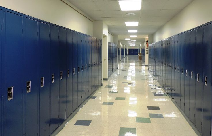 a long hallway lined with blue lockers