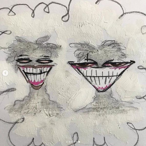 two clown faces are drawn on a piece of paper