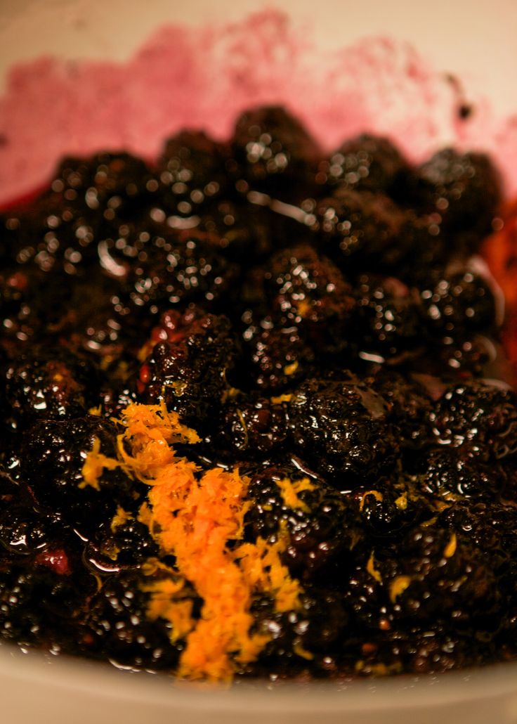 a white bowl filled with black and orange food