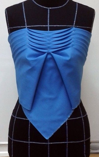 a mannequin with a blue top and black skirt