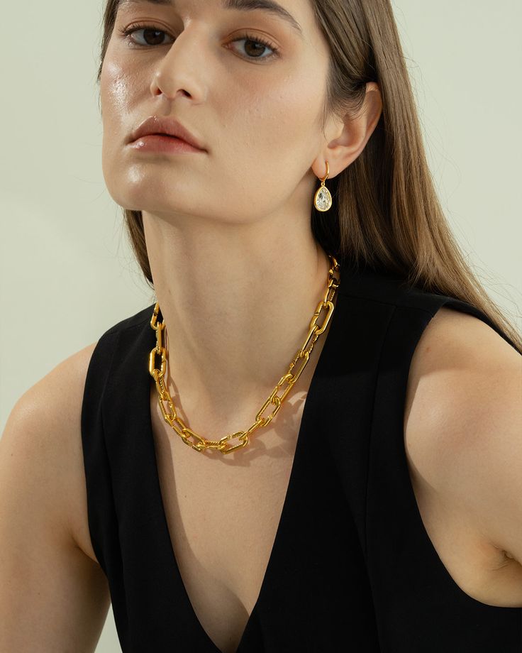 Meet the Kate Chain Necklace—your new go-to for bold elegance. With its striking gold-tone links, this piece transforms any outfit from simple to stunning. Perfect for layering or as a standout solo piece, it’s your ticket to instant glamour. 18k gold over sterling silver Approx. length: 18" Our gold covering on silver is a thick layer of 18k solid gold on sterling silver meaning it will last longer. You get the look and feel of gold jewelry at a fraction of the price. Luxury Solid Link Jewelry For Parties, Luxury Chain Link Necklace For Evening, Elegant Gold Oval Link Chain Necklace, Luxury Chain Link Evening Necklace, Gold-tone Link Chain Necklace For Formal Occasions, Elegant Gold-tone Cable Chain Necklace, Gold Chain Link Necklace For Formal Occasions, Elegant Cable Chain Link Necklace, Modern Yellow Gold Chunky Chain Jewelry