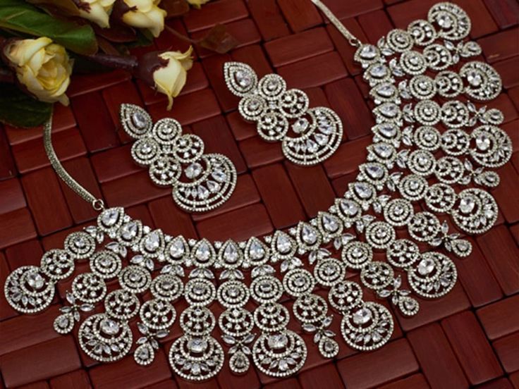 Very Pretty and Gorgeous CZ handcrafted necklace with matching earrings. Necklace length- 18 inches Earrings length- 1.5 inches Earrings weight- 10 grams per earring. Highest quality and craftsmanship Ready to ship from New Delhi, India NOTE: Please provide your phone number( in notes or personal message ) when placing order for this item. Cubic Zirconia Chandbali Wedding Jewelry, Silver Bridal Earrings With Stone Work For Reception, Festive Crystal Jewelry Sets For Wedding, Dazzling Kundan Jewelry Sets, Hand Set, Festive Hand Set Cubic Zirconia Bridal Sets, Dazzling Hand-set Jewelry Set For Reception, Traditional Jewelry Sets With Sparkling Stones For Festive Occasions, Dazzling Hand Set Jewelry For Reception, American Diamond Chandbali Wedding Jewelry