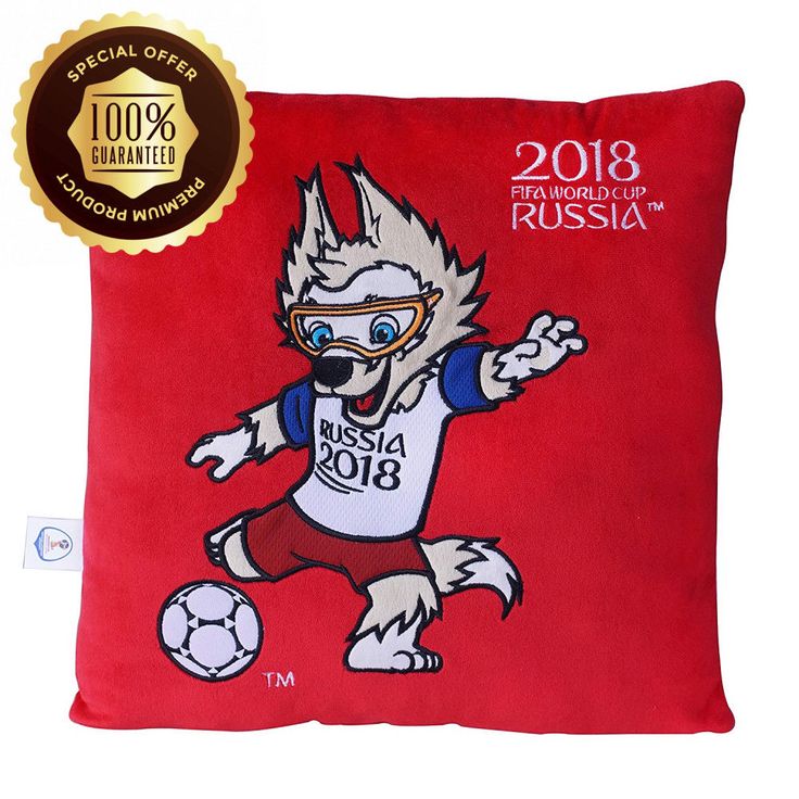 a red pillow with an image of a dog kicking a soccer ball