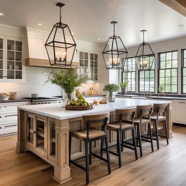 a large kitchen with an island in the middle and lots of counter space on one side