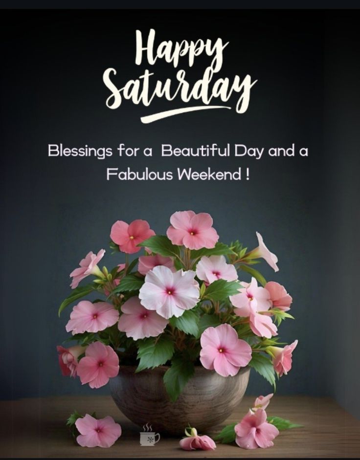 a vase filled with pink flowers sitting on top of a table next to a sign that says happy saturday