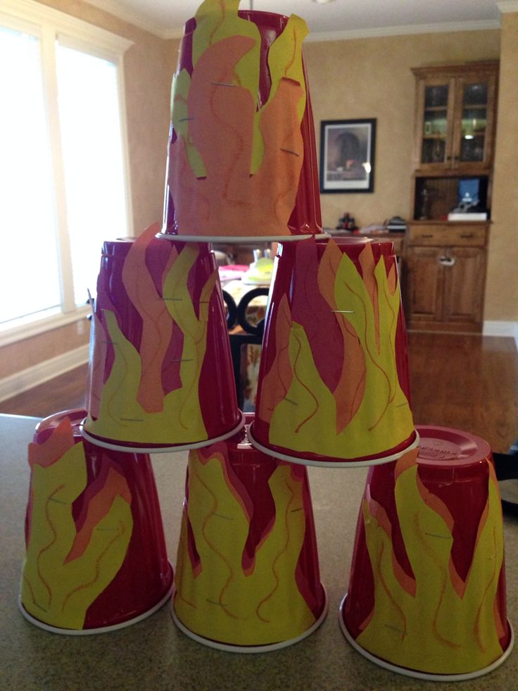 a group of red and yellow cups sitting on top of a counter next to a table