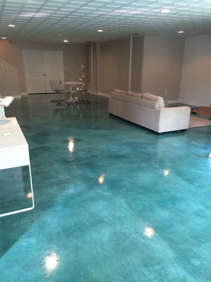 a living room filled with furniture and blue flooring