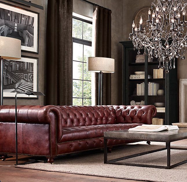 a living room filled with furniture and a chandelier