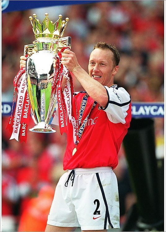 a man holding up a trophy in front of a crowd