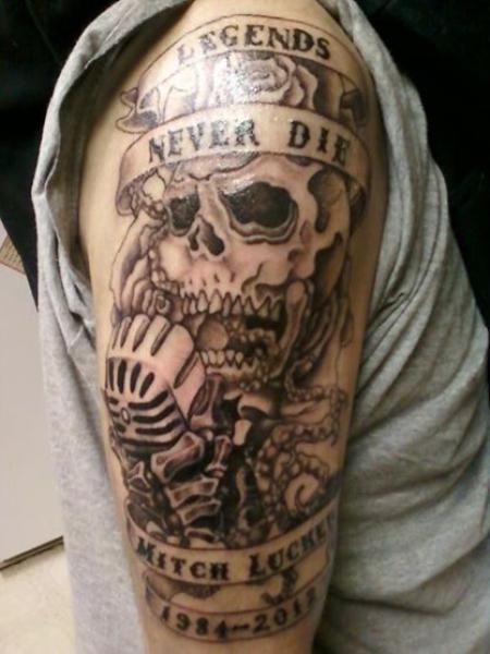 a man with a skull tattoo on his arm