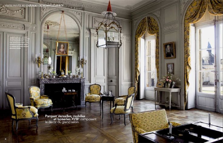 an ornately decorated living room with yellow chairs