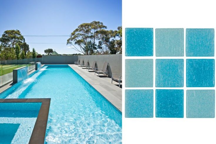 a swimming pool with blue tiles on the side and an image of trees in the background