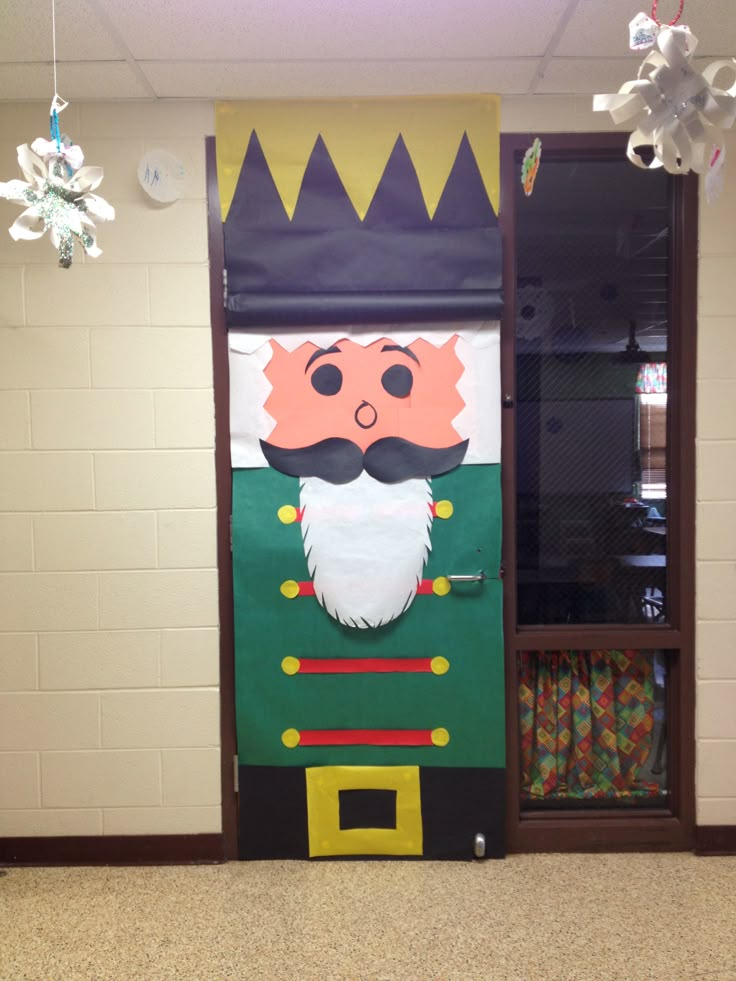 a door decorated to look like a nutcracker with a green coat and beard