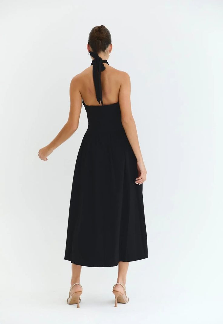 Introducing The Harper Dress in black, a stunning and elegant midi dress perfect perfect for all occasions. With its graceful halter neck and low back, this dress exudes timeless sophistication and grace, making it the must have choice for any event whether it be Wimbledon to Ascot or a garden party. Perfect for strolling around city streets with trainers or dressing up for a evening with heels. Its versatility and effortless style will make you stand out in any setting. Party A-line Midi Dress With Tie Back, Elegant Spring Halter Neck Backless Dress, Spring Formal Halter Neck Dress, Elegant Halter Neck Midi Dress, Spring Formal Backless Dress With Tie Back, Summer Formal Midi Dress With Halter Neck, Elegant Halter Neck Maxi Dress With Tie Back, Summer Formal Halter Neck Midi Dress, Formal Halter Neck Midi Dress For Summer