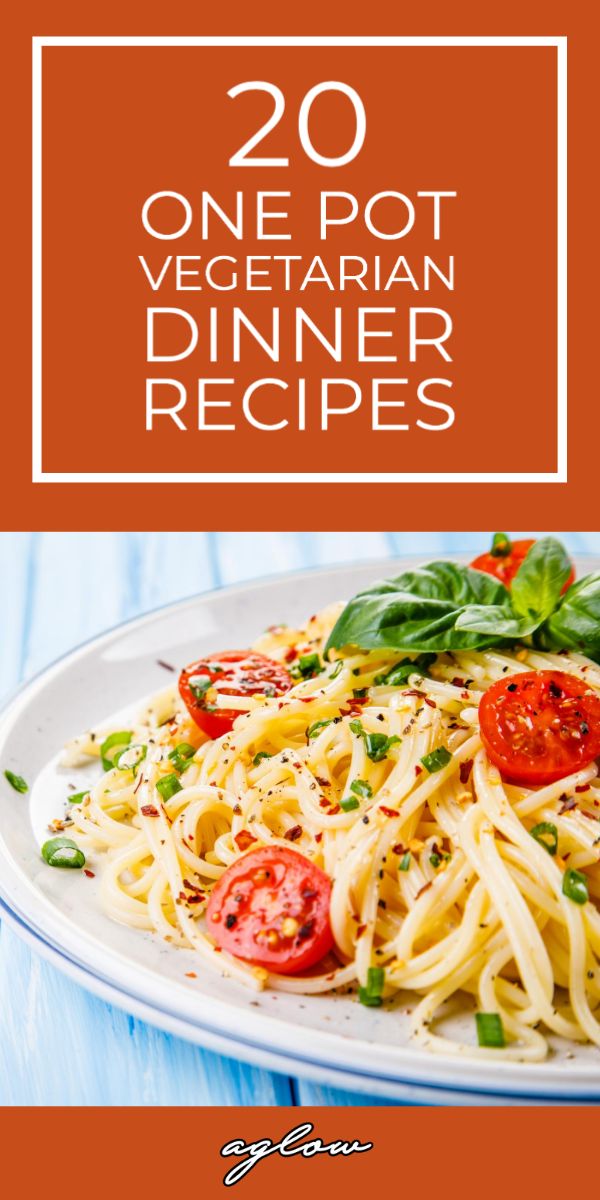 a white plate topped with pasta and tomatoes on top of a blue wooden table next to a