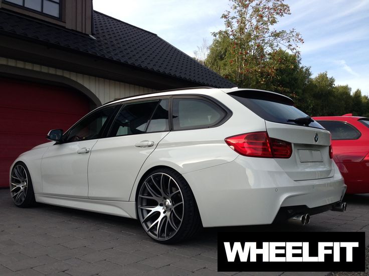 a white car parked in front of a garage door with the words wheel fit on it