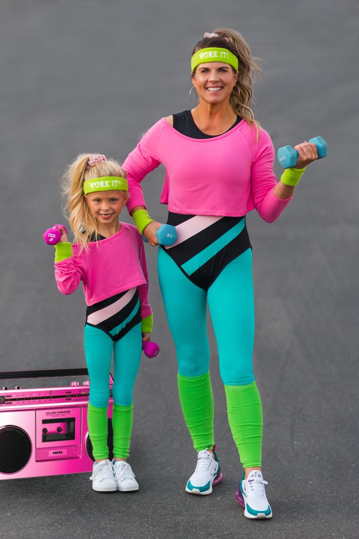 a woman and her daughter are posing for the camera with pink headbands on