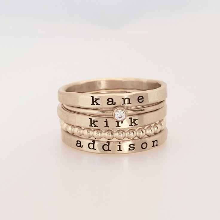 Mother's Day Gift | Personalized stackable ring set, engraved with a name, date, or special word.  Metal: 14k gold filled Dimensions: name rings are 2mm tall on average, but our rings are handmade so variations will occur. Birthstone is 2mm on a 1mm band, and beaded ring is 2mm. Font: lowercase typewriter Unsure what size you need? We highly recommend using our ring sizer for an accurate fit. Some people find that sizing up when stacking 3 or more rings is more comfortable. https://www.etsy.com/ Personalized Gold Stackable Rings For Birthday, Mother's Day 14k Gold Stackable Rings, Customizable Stackable Rings For Mother's Day, Customizable Stackable Rings For Mother’s Day, Personalized Birthstone Birthday Ring, Personalized Adjustable Stackable Rings For Birthday, Custom Name Stackable Rings For Anniversary, Anniversary Stackable Rings With Names, Small Personalized Gifts