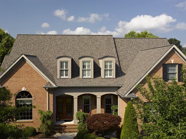 a large brick house with two story windows