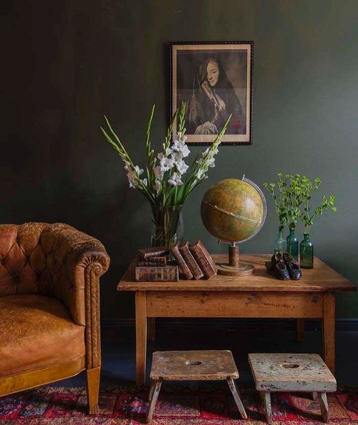 a living room filled with furniture and a globe on top of a wooden coffee table