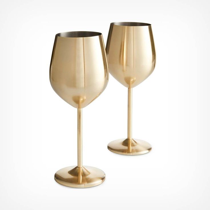 two gold wine glasses sitting side by side