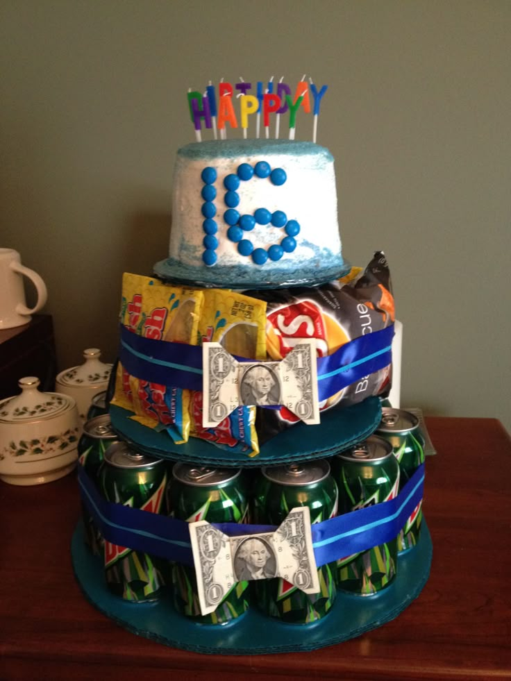 a three tiered birthday cake made out of soda cans and candy bar wrappers