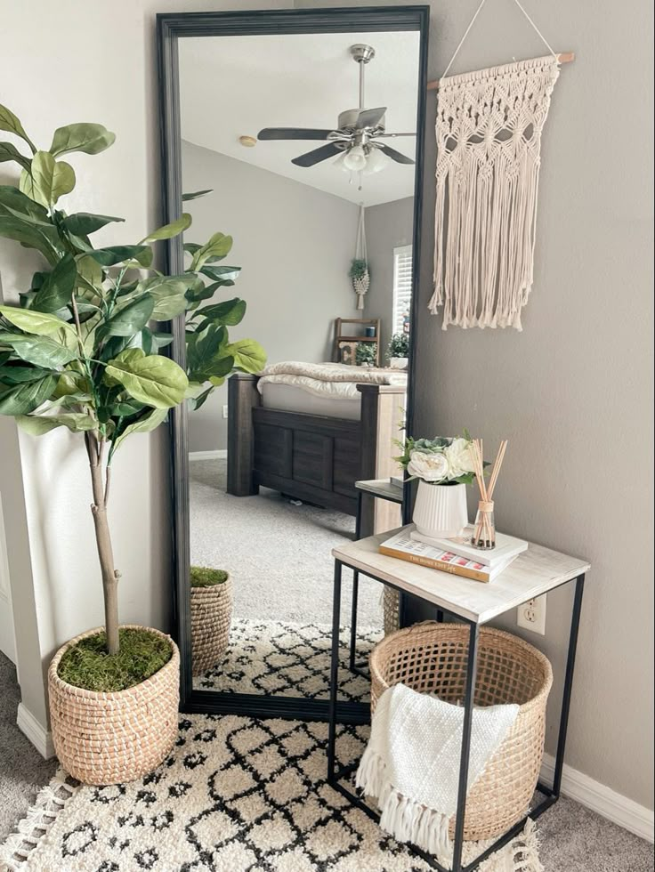 a living room with a large mirror and plants