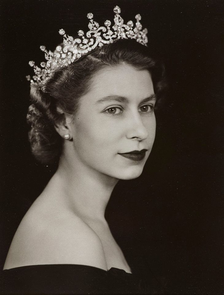 an old black and white photo of a woman wearing a tiara