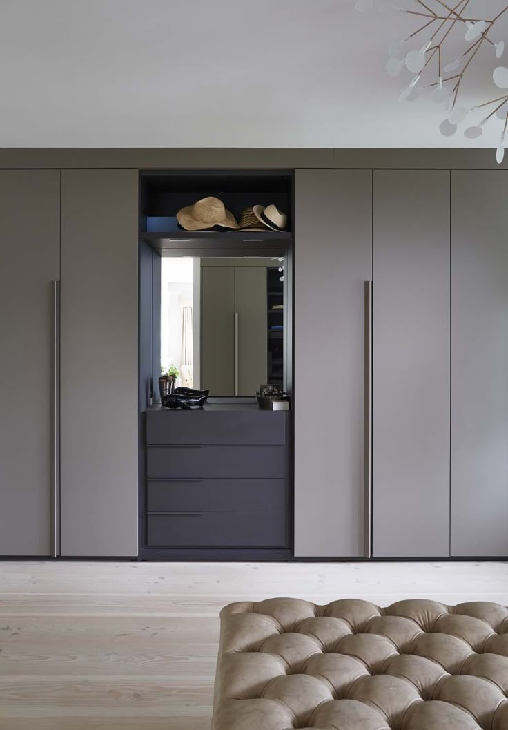 a bedroom with a bed, dresser and closets in the corner that has hats on top of it