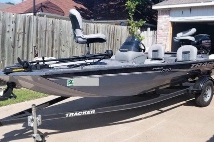 a black and gray boat parked in front of a house