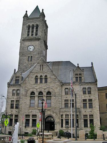 an old building with a clock tower on the front and side of it's face