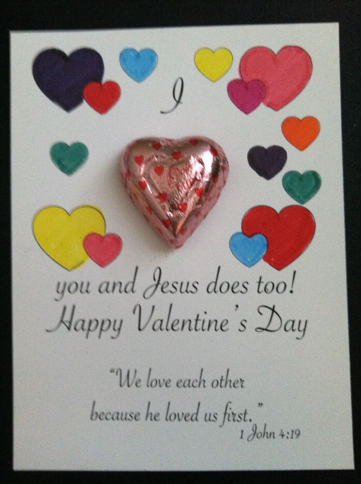 a valentine's day card with a heart shaped candy on the front and colorful hearts around it