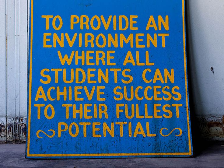 a blue sign that says to provide an environment where all students can achieve success to their fullest potential