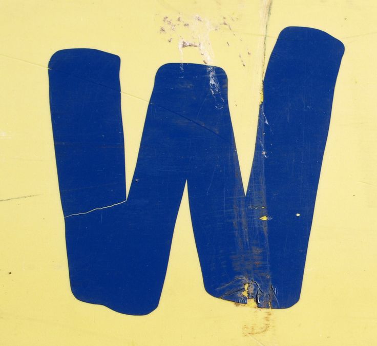 the letter w is painted in blue on a yellow background with white letters and numbers