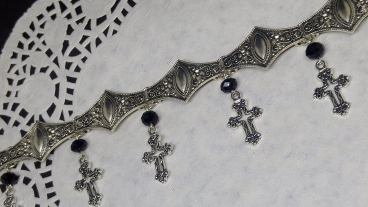 Victorian Gothic metal choker with hollow crosses and black crystal beads, ornate metal necklace, Victorian jewelry, Gothic jewelry A beautifully ornate gothic silver metal choker with Victorian hollow cross charms and black faceted crystal beads. It measures approx. 11 inches in length and has lobster clasp fastening and an extension chain, so that it can be adjusted to fit the neck. The choker is made up of 7 silver toned metal ancient style sections that have intricate detailing. A marvelous Gothic Silver Metal Body Jewelry, Silver Gothic Metal Body Jewelry, Silver Gothic Body Jewelry, Gothic Metal Choker For Festivals, Gothic Silver Jewelry For Festival, Gothic Silver Festival Jewelry, Gothic Nickel-free Silver Body Jewelry, Handmade Silver Gothic Choker, Nickel-free Gothic Silver Body Jewelry