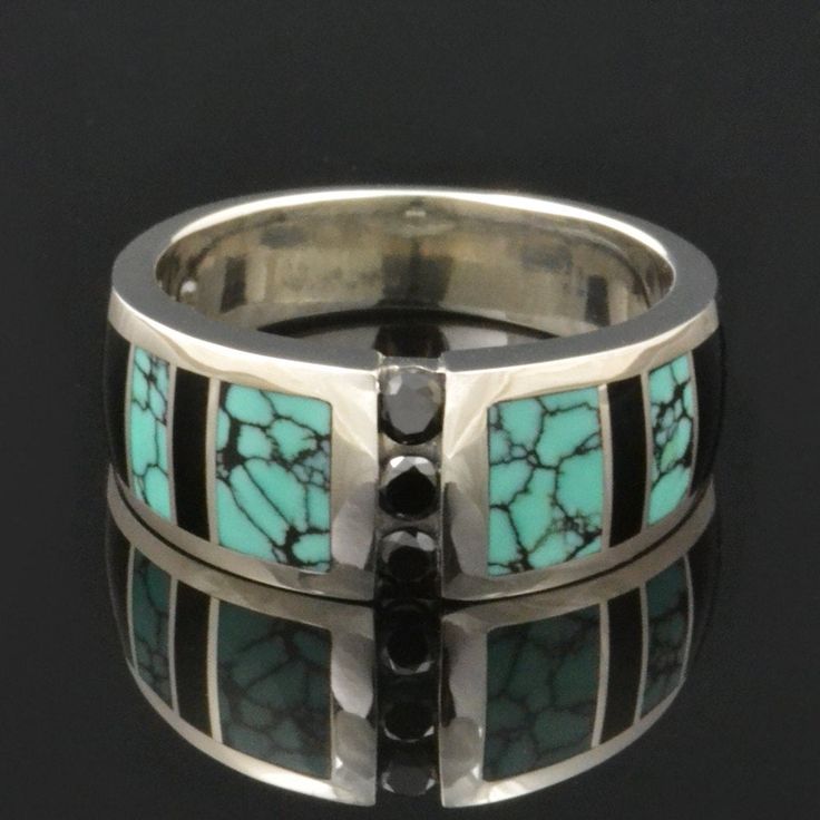 "Spiderweb turquoise ring with black onyx and black diamond accents designed by Mark Hileman. This woman's handmade band features 3 channel set round black diamonds flanked by alternating black onyx and spiderweb turquoise inlay. The 3 black diamonds weigh a total of .18 carats. The ring is 8.5mm wide at the widest point and will be made to order in your size in 3 to 6 weeks. This band is available in other color combinations and in 14k gold or stainless steel for an additional charge. It is han Black Round Cut Jewelry With Accent Stones, Luxury Jewelry With Multi-stone Round Shape, Luxury Multi-stone Round Jewelry, Fine Onyx Jewelry For Anniversary, Fine Jewelry With Inlay For Anniversary, Black Inlay Jewelry As A Gift, Modern Jewelry With Accent Stones For Anniversary, Black Jewelry With Inlay For Gift, Luxury Inlay Rings For Anniversary