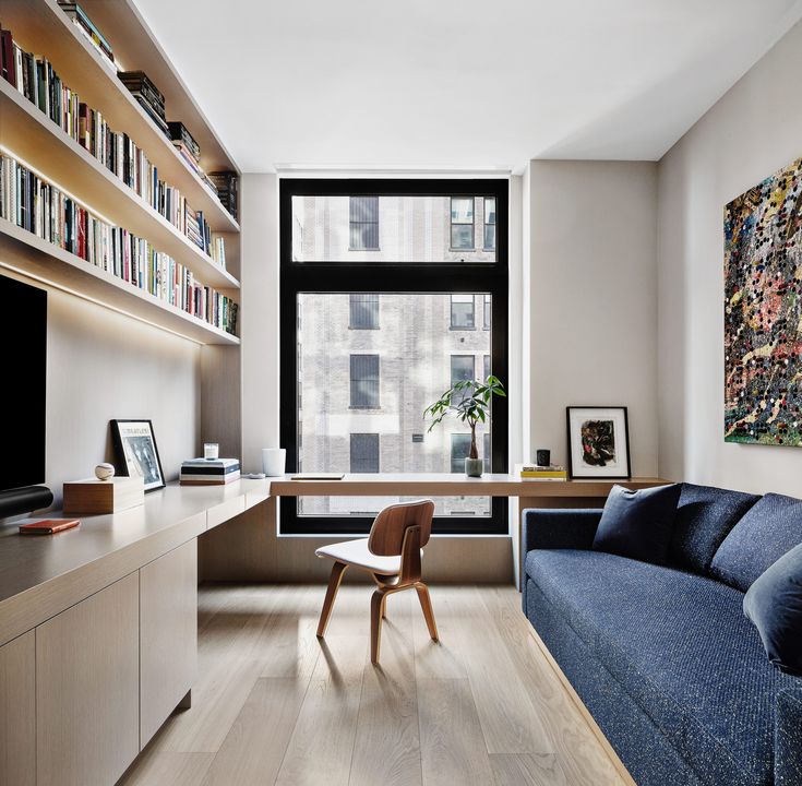 a living room filled with furniture and a flat screen tv sitting on top of a wooden shelf