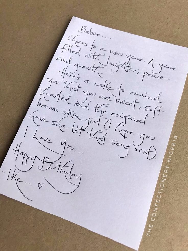 a handwritten birthday card on top of a piece of paper