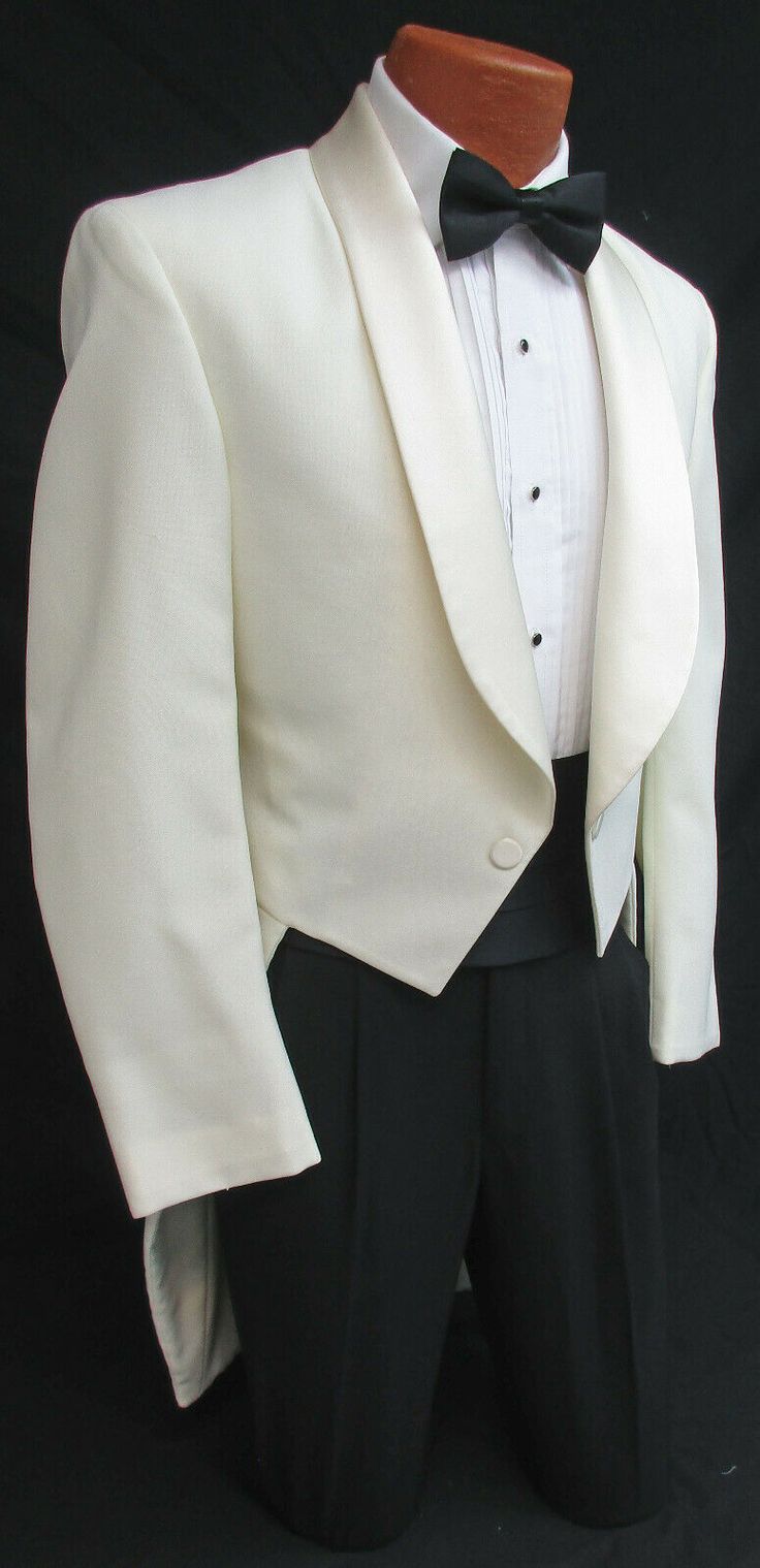 NEW IVORY TUXEDO TAILCOAT Two Button Front with Satin Shawl Lapels. Traditional Tails in the Back. Durable & Machine Washable Polyester. High Quality Made in the USA! Please note these feature a zipper inside the coat underneath the lapels.  Not visible while worn I just thought I should mention it.  Listing is for the tailcoat only.  Please visit my eBay Store if you are interested in additional formal wear items. White Wedding Tuxedo With Button Details, White Wedding Tuxedo With Buttons, White Wedding Tuxedo With Detailing, White Wedding Suits With Buttons, White Wedding Blazer With Buttons, Classic White Wedding Blazer, Fitted White Tuxedo With Buttons, White Single Breasted Tuxedo For Wedding, White Fitted Tuxedo With Buttons