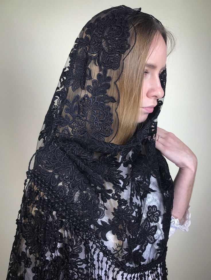 a woman wearing a black lace shawl