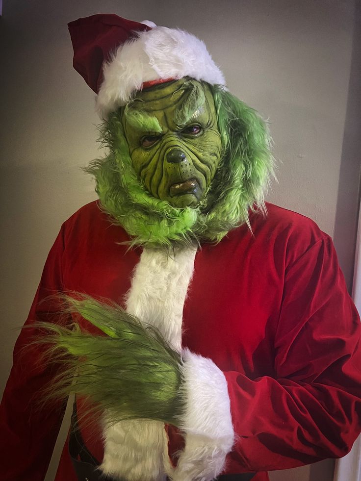 a man in a santa claus outfit is dressed up as the grinch for christmas