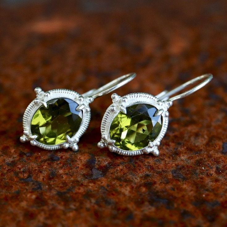 Renaissance jewelry is splendidly reborn. This design belongs at a ball, or at least at a local nightclub. Peridot set in sterling silver with European lever-backs for pierced ears. Size: 1 Inch. Sterling Silver Jewelry For May Birthstone Party, Sterling Silver May Birthstone Jewelry For Party, Elegant Sterling Silver Earrings For May Birthstone, Elegant Sterling Silver Earrings With May Birthstone, Classic Nickel-free Jewelry For May Birthstone, Classic Pierced Jewelry For May Birthstone, Sterling Silver Jewelry With Lever Back For Party, Classic Sterling Silver May Birthstone Earrings, Sterling Silver Drop Earrings With Bail