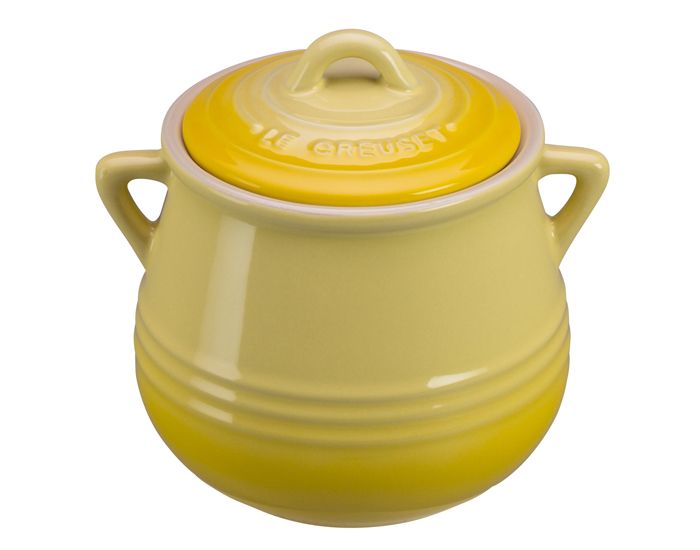 a yellow crock pot sitting on top of a white table