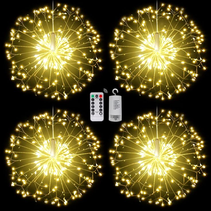 four firework lights with remote controls in the middle one is yellow and three are white