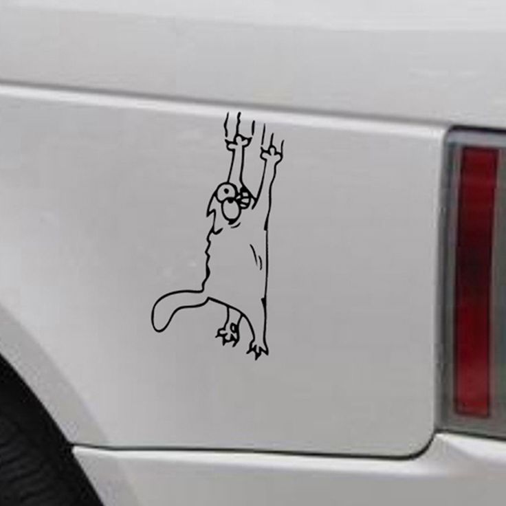 a sticker on the back of a car that has a dog hanging from it