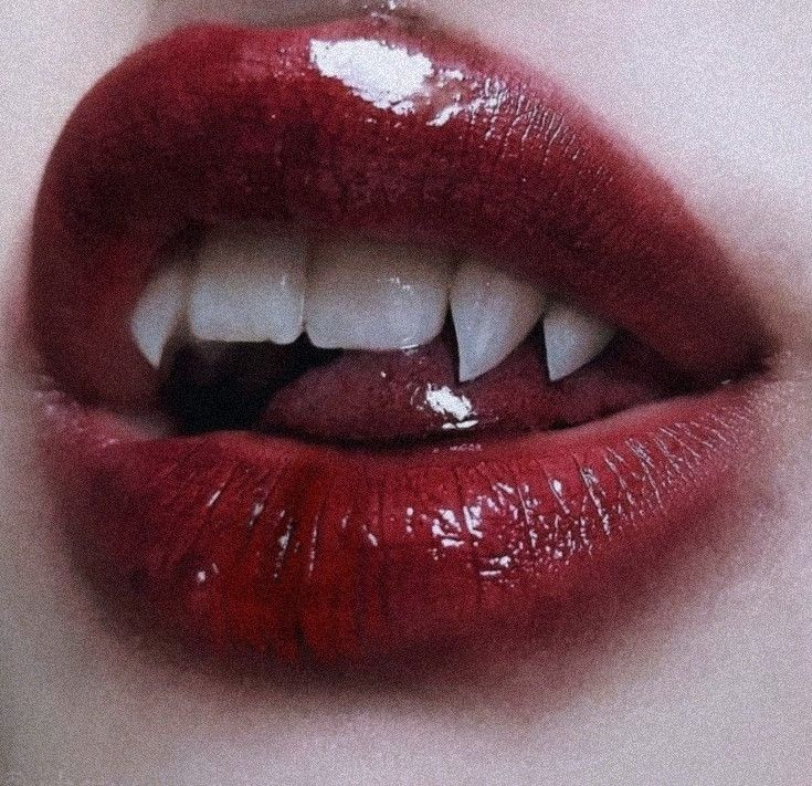 a woman's lips with white teeth and red lipstick