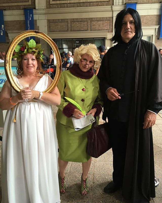 three people dressed up in costumes posing for a photo with an old man and woman