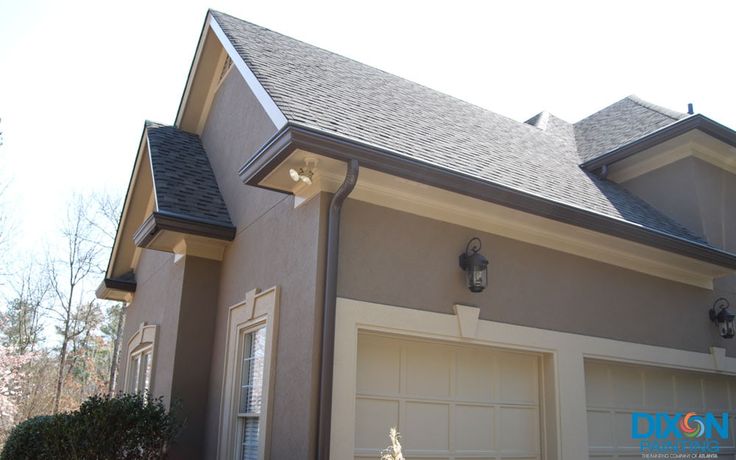 a house with two garage doors and windows