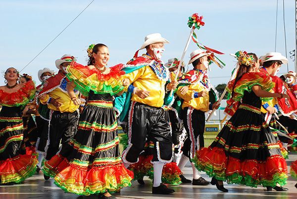 a group of people that are standing in the street with some kind of dance costume